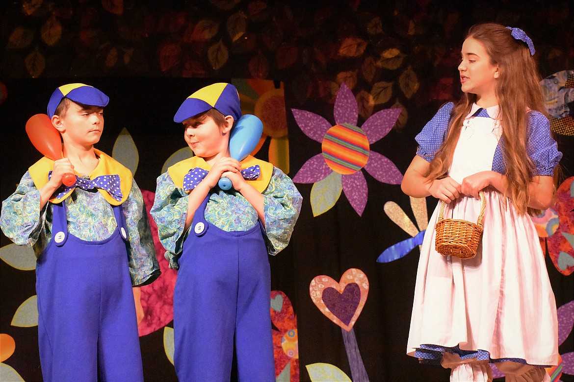 Nicholas Harper as Tweedle Dee, Tommy Guinard as Tweedle Dum and Adele Roesler-Begalke as Alice perform in Alice in Wonderland at Troy High School gym Saturday. See more photos on page B1. (Photo by Svetlana Harper)