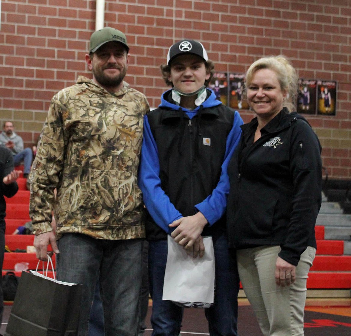 Courtesy photo
Wallace wrestler Trevor Harshman stands with his parents Cory and Karen Harshman during Harshman&#146;s senior night honoring.