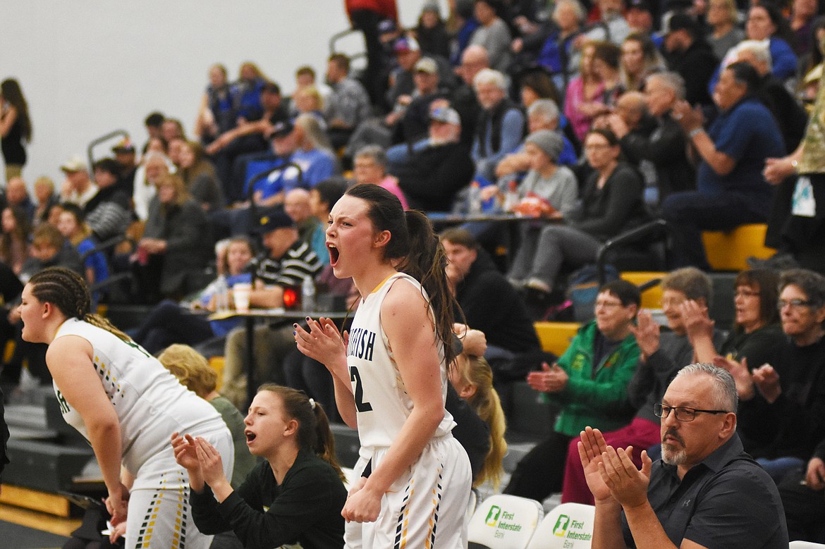 The Lady Dogs bench cheers after a made bucket against Columbia Falls Thursday night at Whitefish High School.