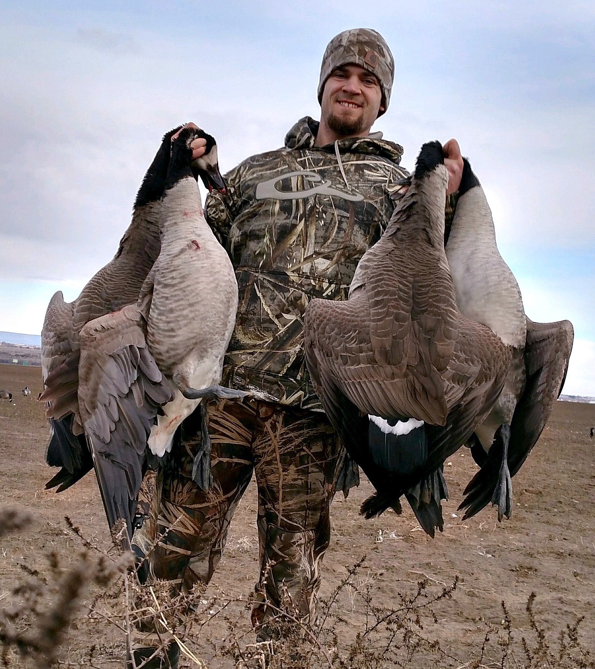 Pete Fisher photo - A member of the Hendricks party shows four nice geese!