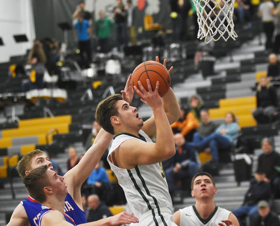 Bulldogs guard Ryan Kemm drives to the hoop against Columbia Falls Thursday night at Whitefish High School. (Daniel McKay/Whitefish Pilot)