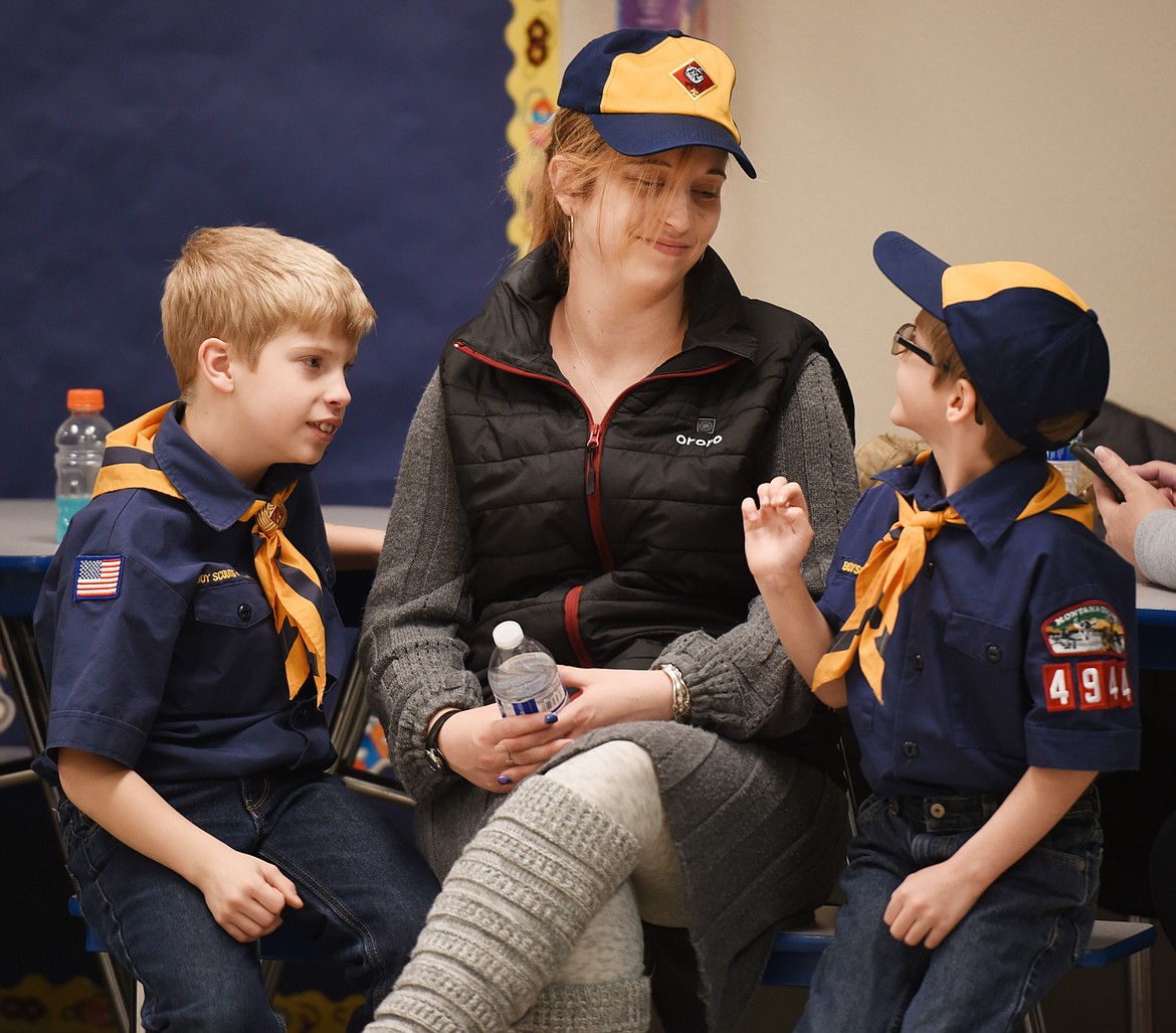 From left, Mason Roloff, 7, his mother Cora Roloff, and her nephew Trace Roloff, 8, enjoy a moment together before the start of the Pack 4944 meeting. Pack 4944 is the oldest pack in the Flathead Valley and one of the oldest in Montana.