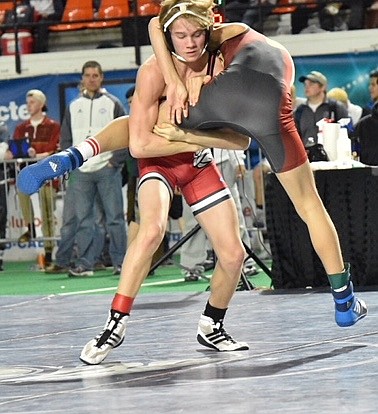 (Photo by ANN DICKINSON)
Junior Casey Olesen, pictured lifting his opponent, won twice and lost twice at the state last weekend.