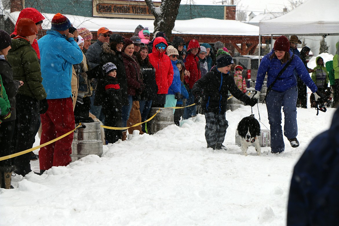 (Photo by CAROLINE LOBSINGER)A duo help their dog race down the tracl during Sunday's K9 Keg Pull.