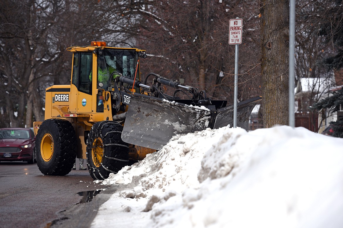 Mike Nelson of the Kalispell Public Works Department clears snow away from storm drains along Third Avenue East at Sixth Street East on Wednesday. Kalispell received 25.6 inches of snow in February, well above the monthly average of 8 inches. (Casey Kreider/Daily Inter Lake)