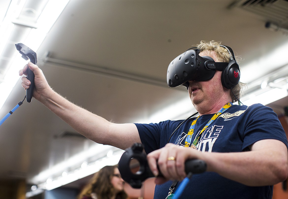 LOREN BENOIT/Press
Lake City High School computer technology teacher Scott Jacobson plays an HTC Vive virtual reality game Friday afternoon at Gizmo&#146;s classroom inside the Hedlund Building at North Idaho College.