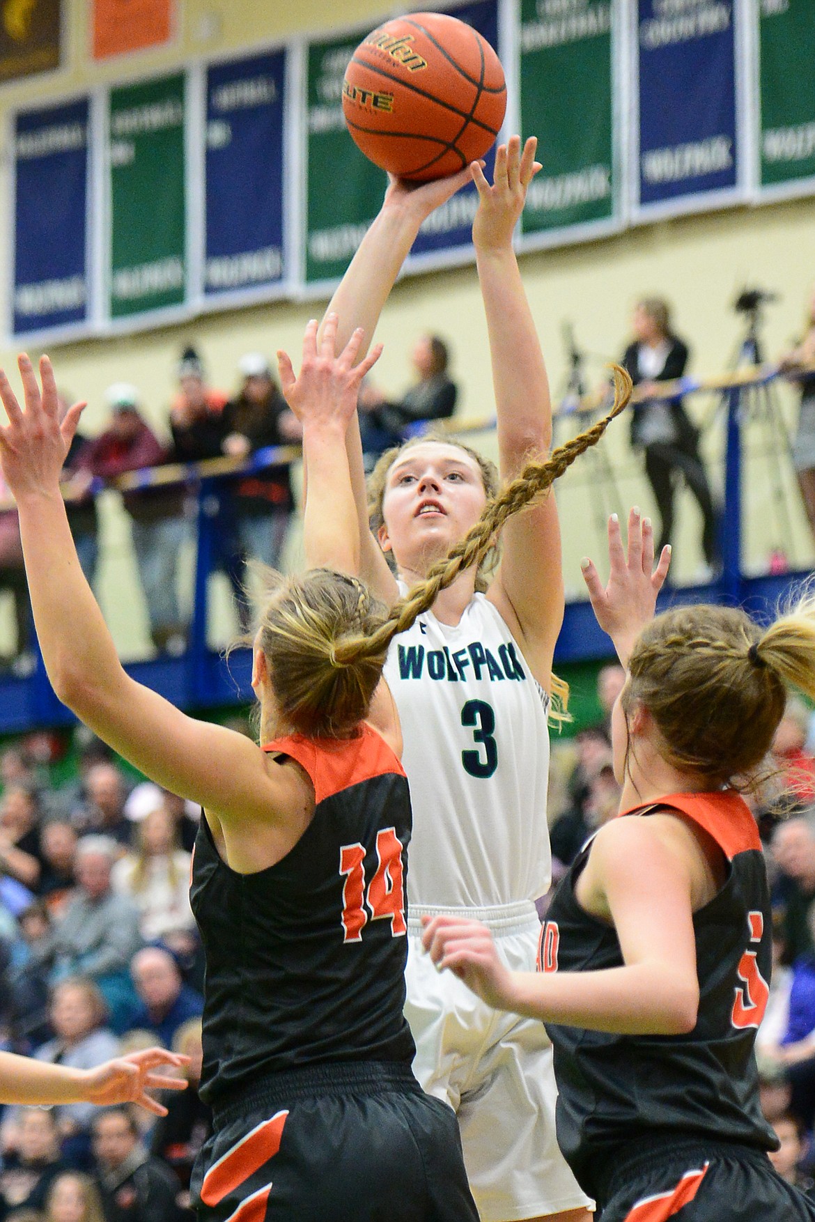 Glacier&#146;s Kali Gulick shoots with Flathead&#146;s Mary Heaton (14) and Maddie Walter defending. The Lady Wolfpack went on to claim a 30-24 crosstown victory Thursday night at Glacier High School. (Casey Kreider/Daily Inter Lake)