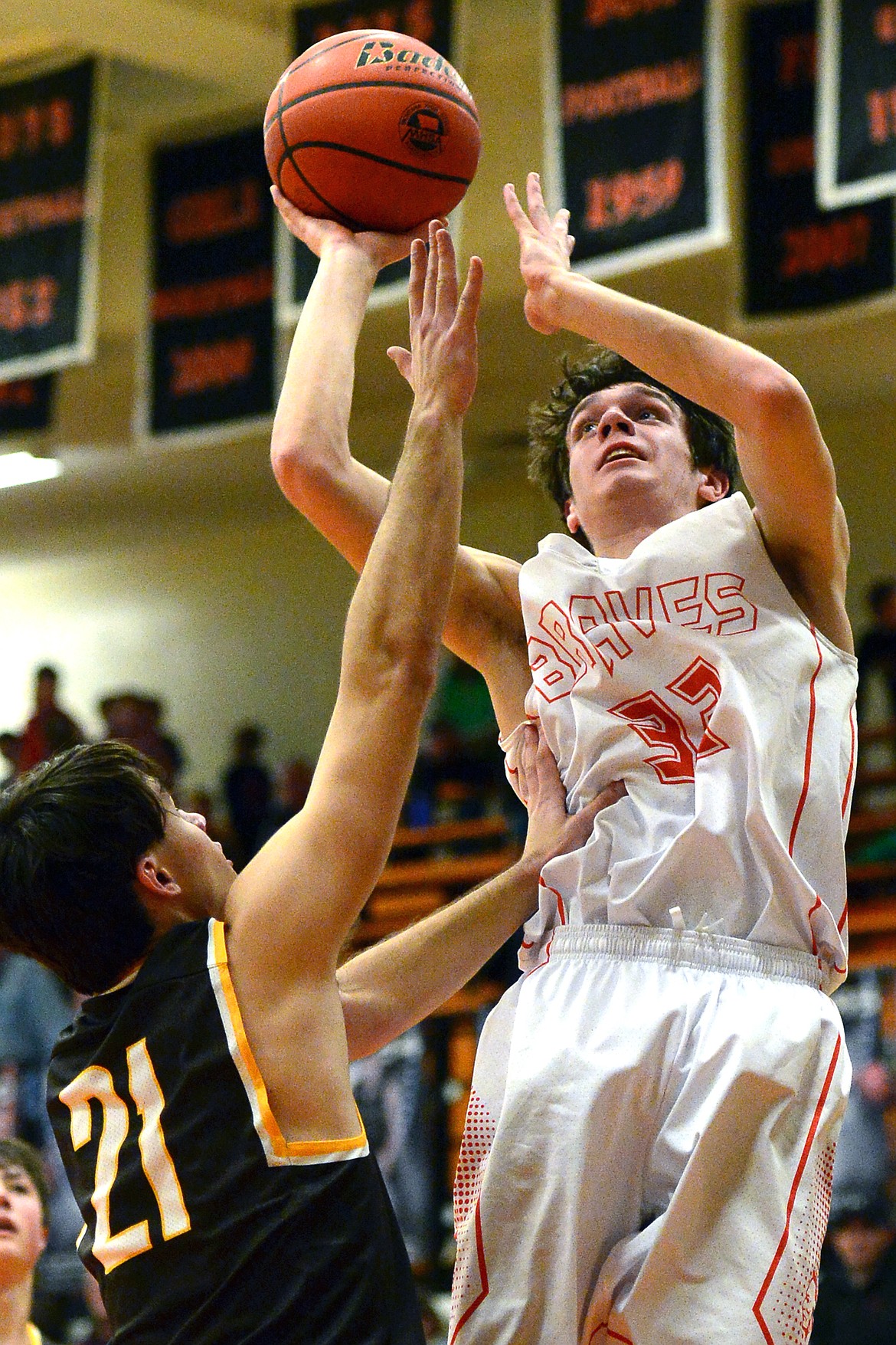 Flathead's Tyler Johnson lays in two points over Helena Capital's Mark Northey on Friday. (Casey Kreider/Daily Inter Lake)