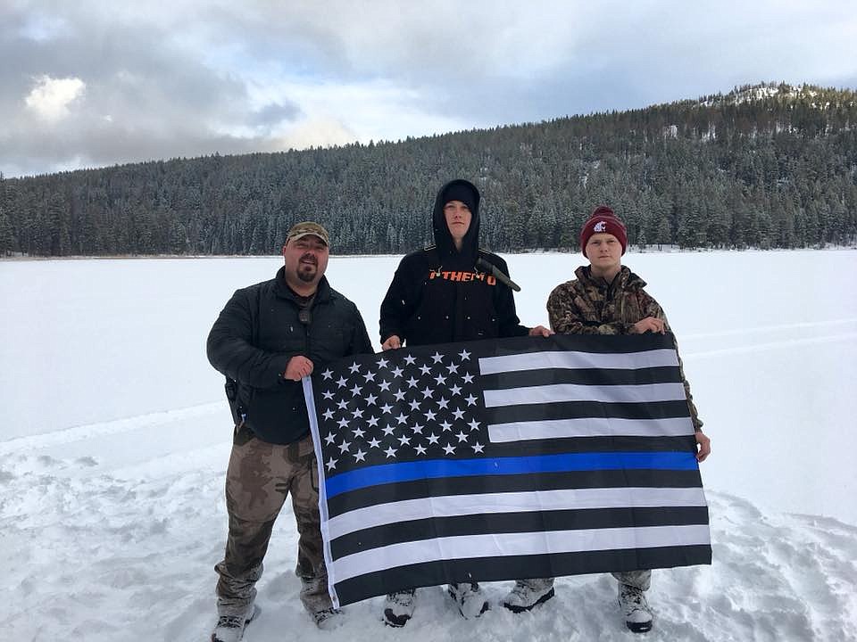 Courtesy photo
Seth Carlson, Avery Field, and Kolby Snyder pose with the &#145;Thin Blue Line&#146; variant of the U.S. flag near Bonaparte Lake.