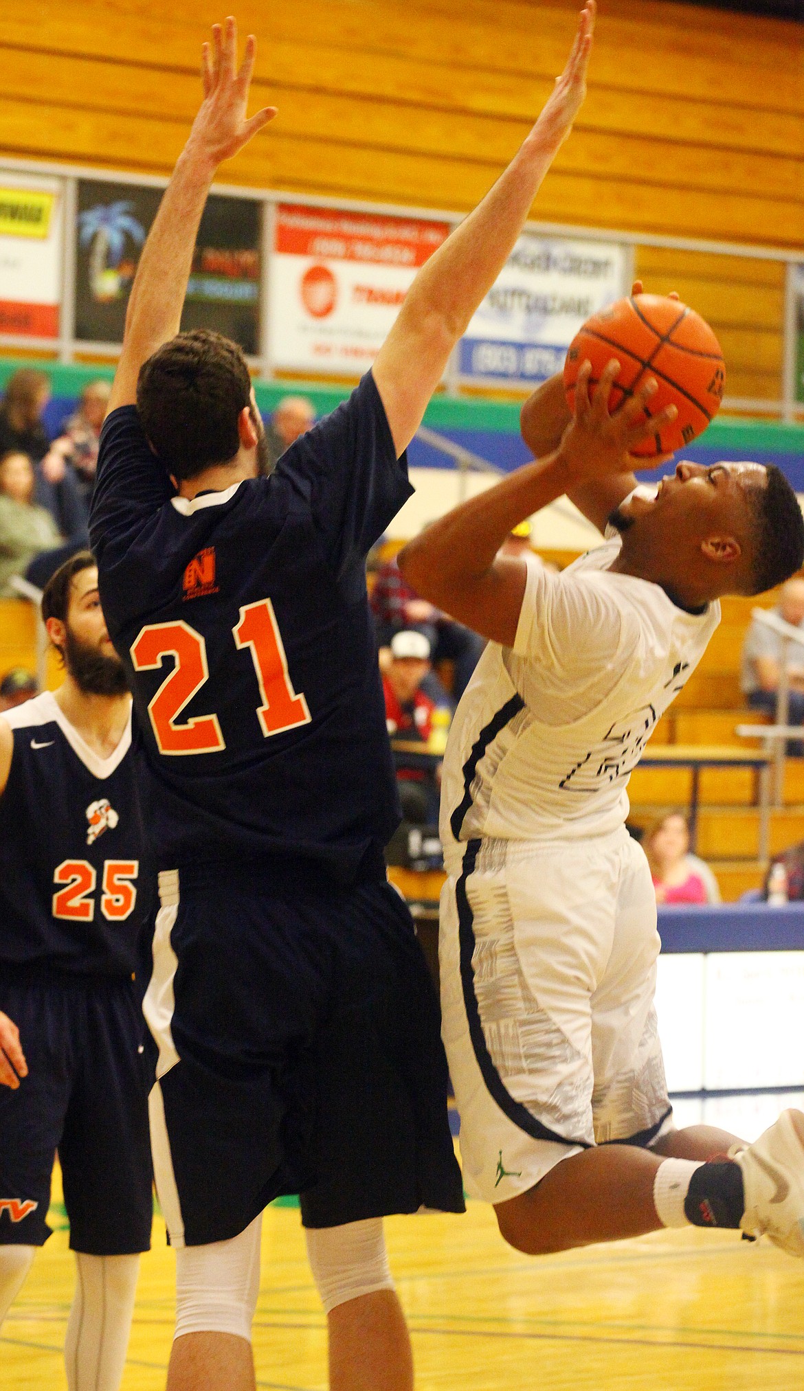 Rodney Harwood/Columbia Basin Herald
Runnin' Vikes shooting guard DeAngelo Stowers (33) goes up against 6-foot-11 Treasure Valley center Jarek Schetzle during the first half of Saturday's NWAC East game at DeVries Activities Center.