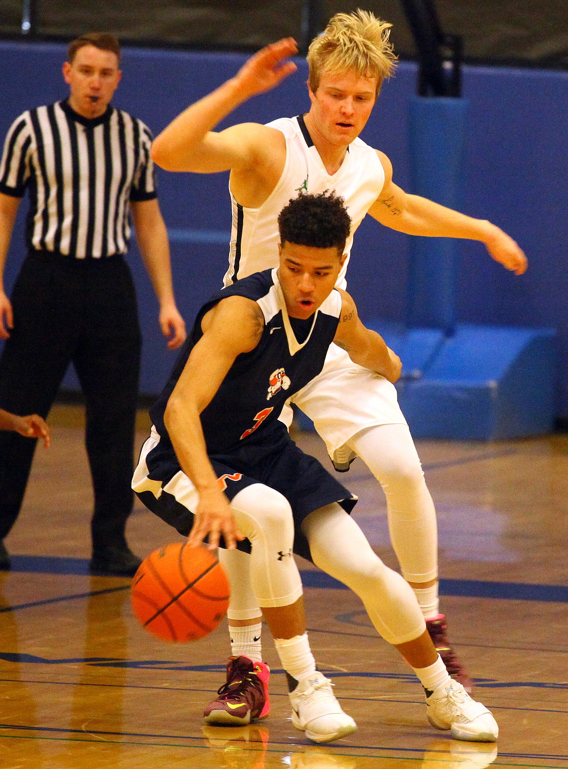 Rodney Harwood/Columbia Basin HeraldBig Bend guard Collin Ahmann (5) of Ephrata defends against Treasure Valley point guard Tyus Jeffereson (3) during Saturday's NWAC East action at DeVries Activities Center.