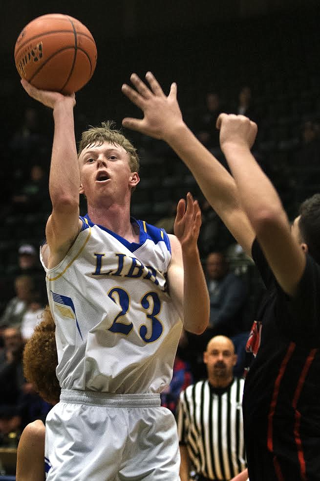 Libby's Ryggs Johnston goes up for two of his 12 points against Ronan at the Western Divisional Tournament in Butte Friday. (Jeremy Weber photo)