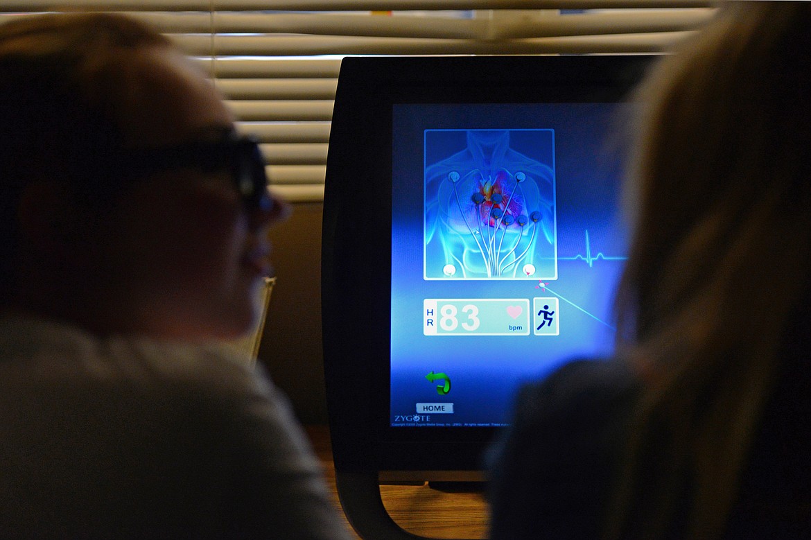 Eighth-graders Abby DeGolier, left, and Hailie Holm work in the zSpace learning lab during teacher Tom Berquist's science class at Columbia Falls Junior High on Thursday. zSpace uses augmented and virtual reality technology to create an interactive experience using a desktop computer. (Casey Kreider/Daily Inter Lake)