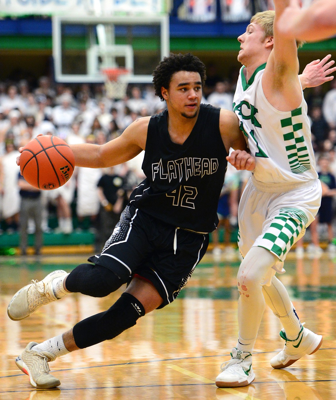 Flathead&#146;s Anthony Jones looks for room against Glacier&#146;s Brec Rademacher during a 59-56 crosstown victory for the Braves Thursday night at Glacier High School. (Casey Kreider/Daily Inter Lake)