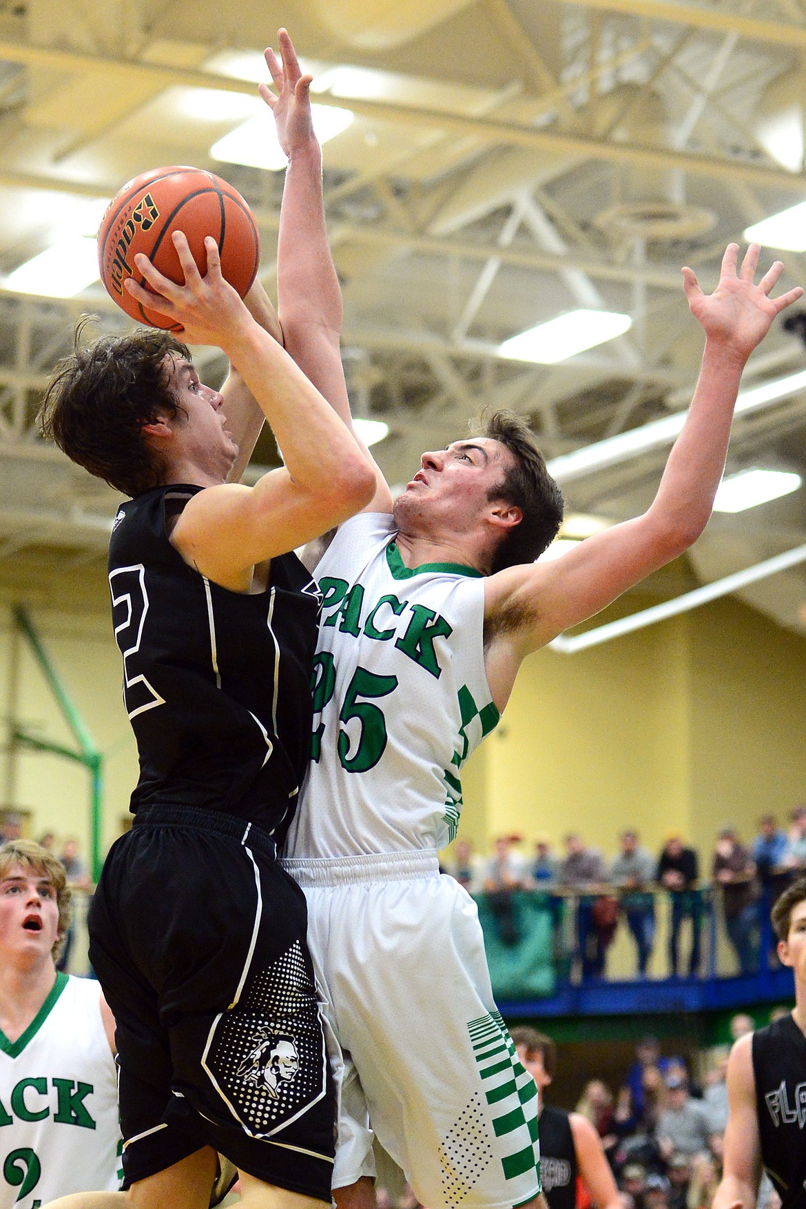 Flathead&#146;s Tyler Johnson looks to shoot with Glacier&#146;s Nick Whitman (25) defending during a 59-56 crosstown victory for the Braves Thursday night at Glacier High School. (Casey Kreider/Daily Inter Lake)