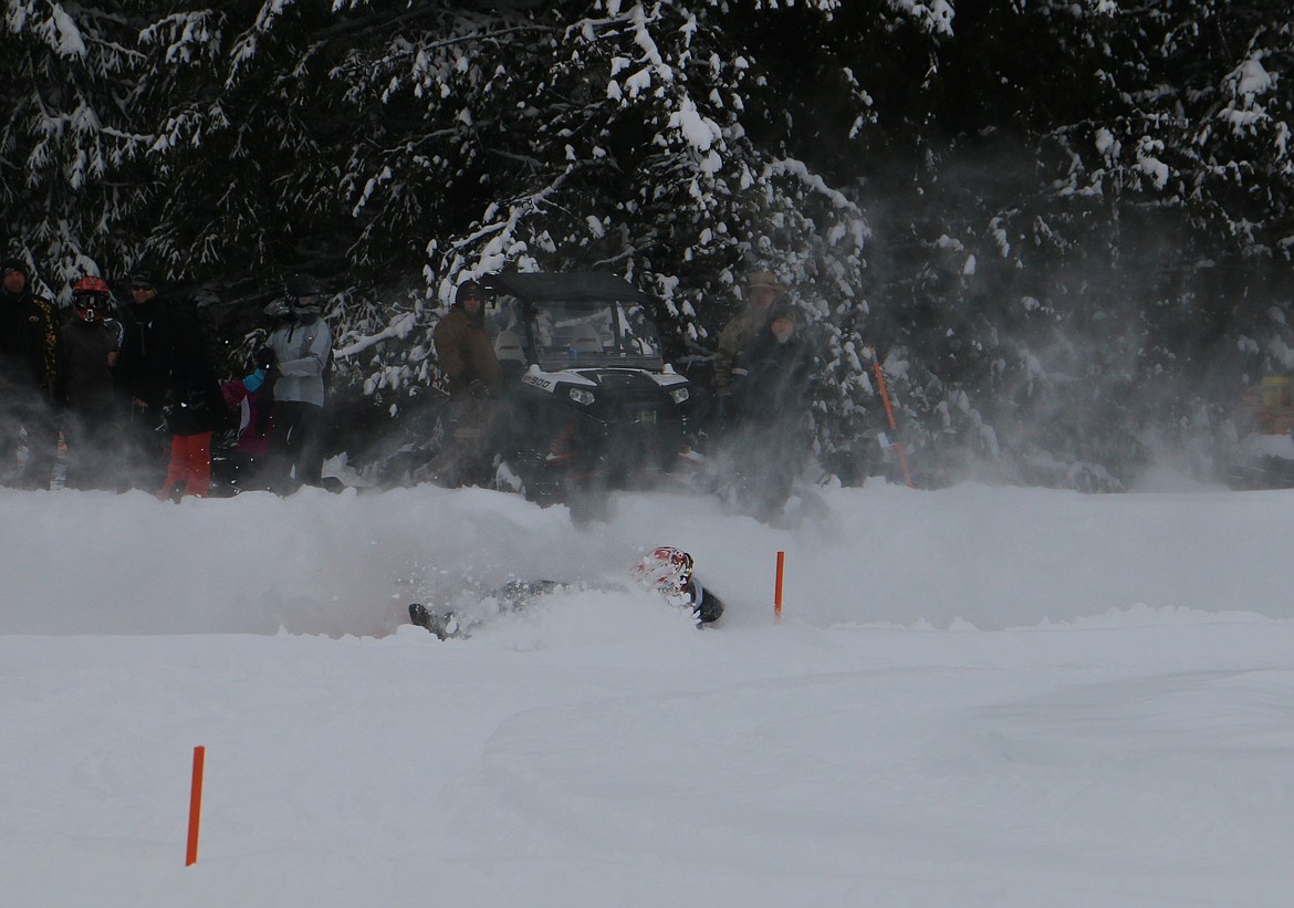 (Photo by MARY MALONE)
A racer loses his sled as the track got a bit slick during the Vintage Snowmobile Races in Priest Lake on Sunday.