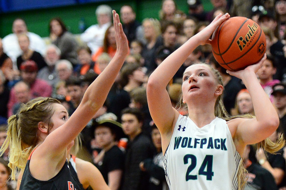 Glacier&#146;s Kaileigh Crawford shoots over Flathead&#146;s Maddie Walter during a 30-24 crosstown victory for the Lady Wolfpack Thursday night at Glacier High School. (Casey Kreider/Daily Inter Lake)