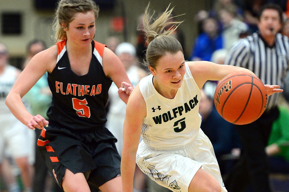 Glacier&#146;s Cadie Williams chases down a loose ball near midcourt in front of Flathead&#146;s Maddie Walter during a 30-24 crosstown victory for the Lady Wolfpack Thursday night at Glacier High School. (Casey Kreider/Daily Inter Lake)