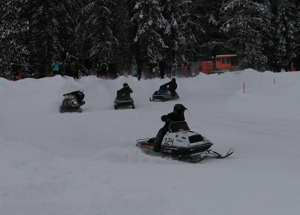 (Photo by MARY MALONE)
Racers take the corner during the annual Vintage Snowmobile Races in Priest Lake Sunday.