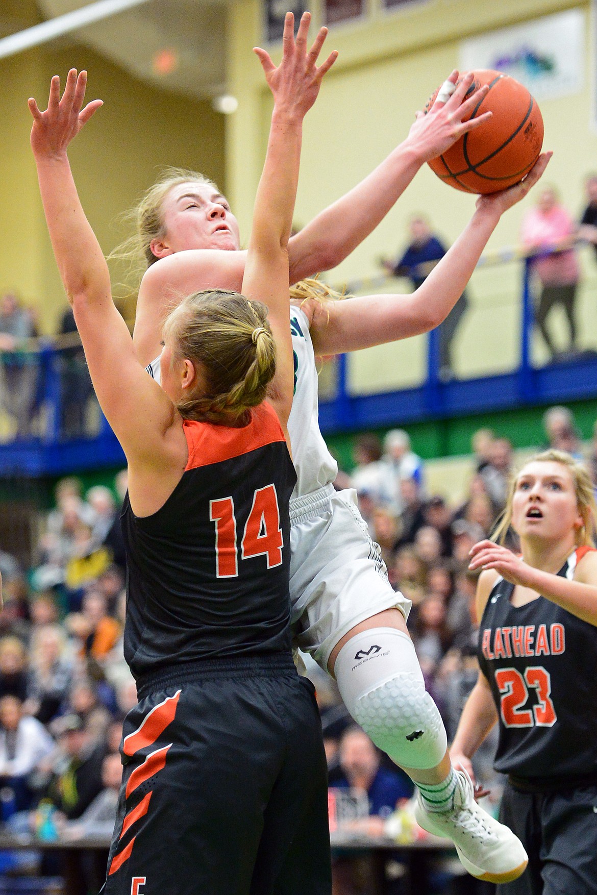 Glacier&#146;s Anna Schrade drives to the hoop over Flathead&#146;s Mary Heaton during a 30-24 crosstown victory for the Lady Wolfpack Thursday night at Glacier High School. (Casey Kreider/Daily Inter Lake)