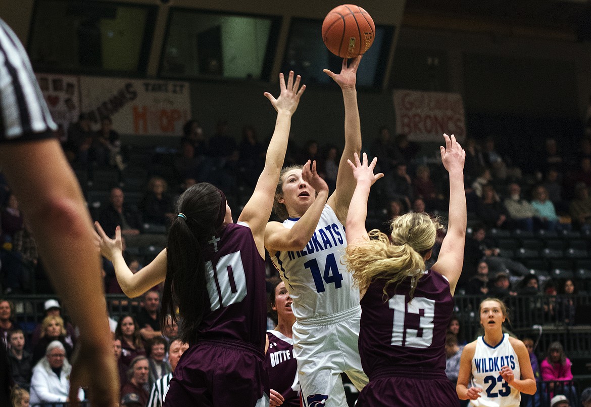 Josie Windauer takes a shot for the Wildkats over Butte Central defenders Cassidy Strizic (10) and Megan Michelotti (13) at the Western A Divisional Tournament in Butte Thursday. (Jeremy Weber photo)