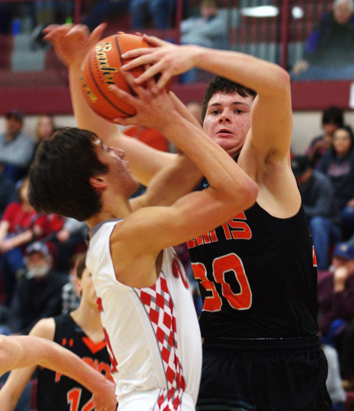 Matt  McCracken (30) blocks an Arlee Warrior from making a basket during the championship game. (Jason Blasco/ Lake County Leader)