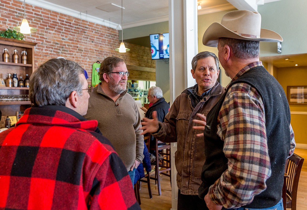 Sen. Steve Daines, second from right, speaks with Lincoln County commissioners Mike Cole, right, Jerry Bennett, foreground, and Mark Peck at Cabinet Mountain Brewery in Libby on Feb. 20. The commissioners recently wrote Daines, asking him to include Ten Lakes WSA in his proposed legislation that would remove the WSA designation from a number of areas in Montana. (John Blodgett/The Western News)
