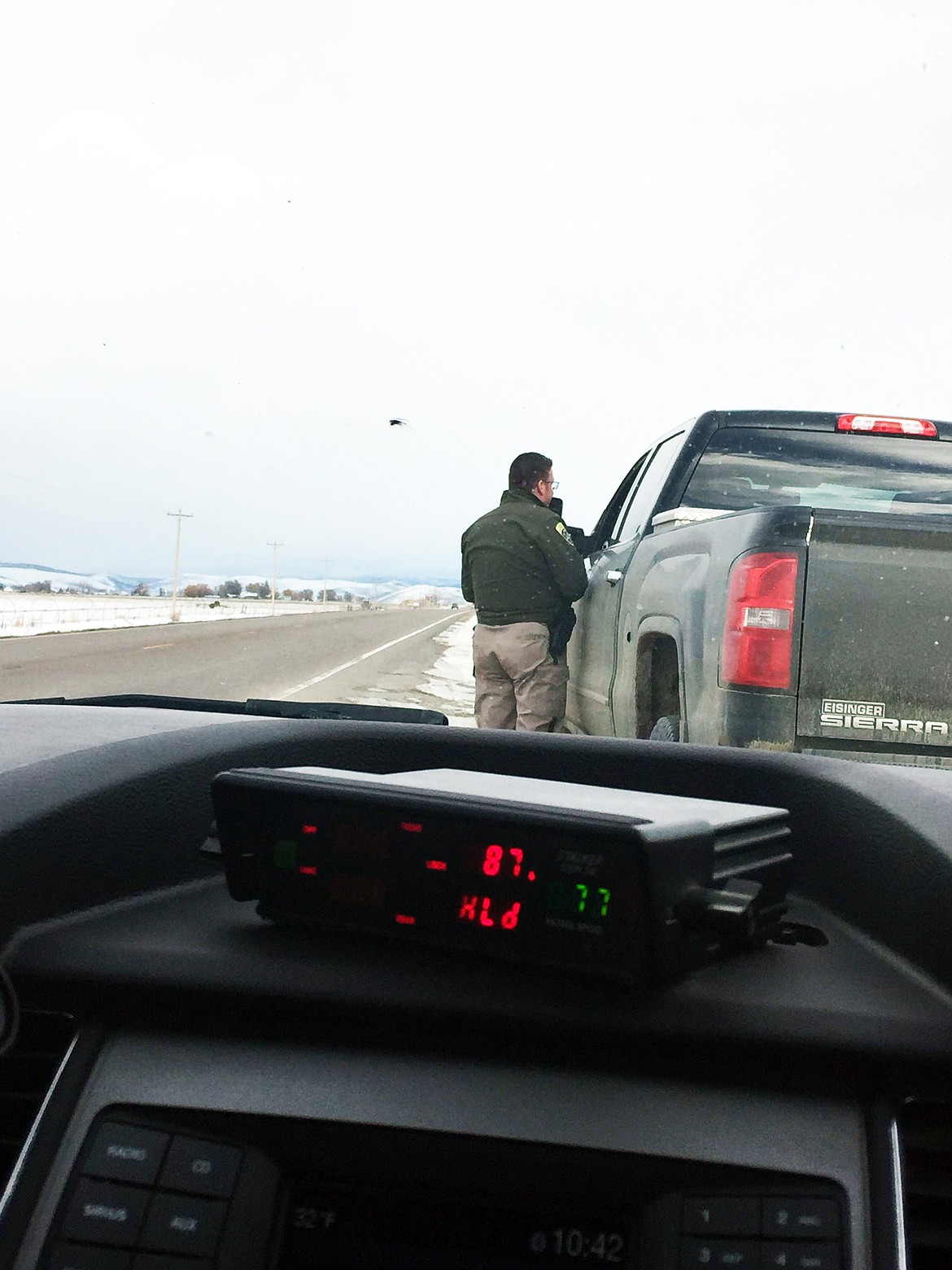 Montana Highway Patrol Trooper Steve Spurr talks with a driver last week who was clocked doing 17 miles over the posted speed limit. (Erin Jusseaume/ Clark Fork Valley Press)