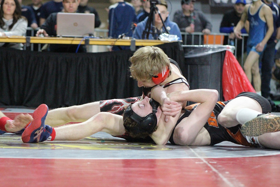 Miner wrestler Austin McKinnon applies a headlock to his opponent.