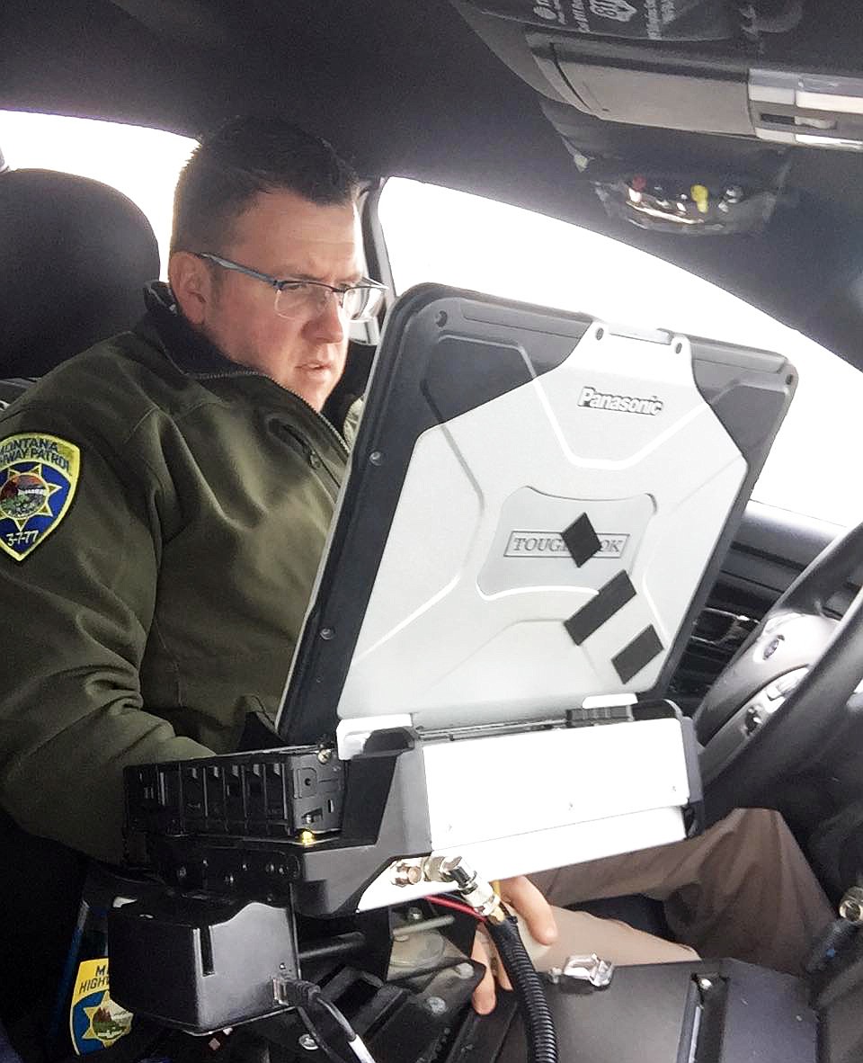 Patrol Trooper Steve Spurr runs a license check on a driver pulled over for speeding. (Erin Jusseaume/ Clark Fork Valley Press)