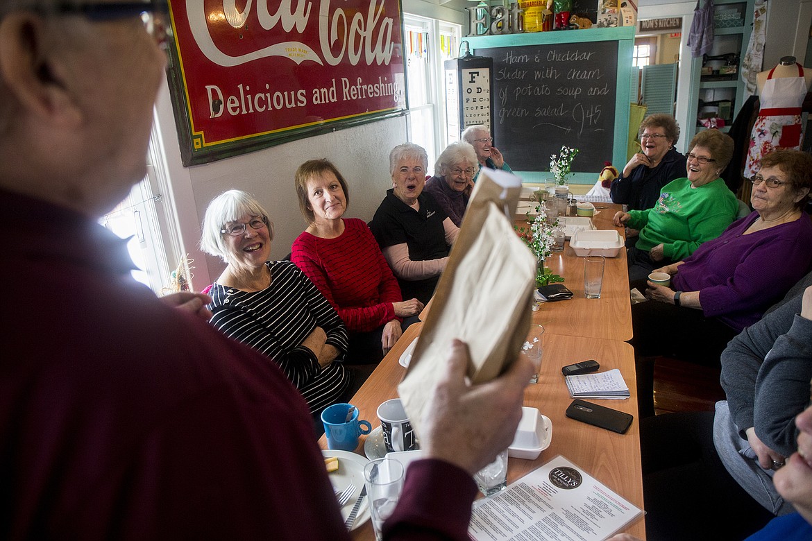 Bob Small, program director for Area Agency on Aging, makes a joke with volunteers from the Post Falls Senior Center before he hands out goodie bags during an RSVP honors lunch Tuesday afternoon at Tilly's Restaurant. (LOREN BENOIT/Press)