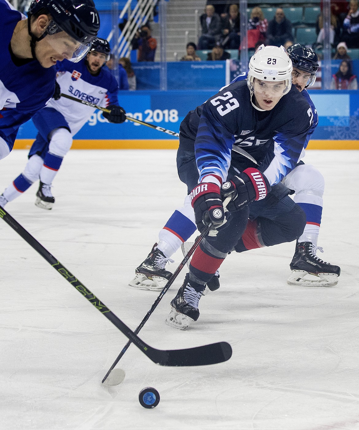 Marek Daloga (71) and Troy Terry (23) fight for the puck in the first period against Slovakia Tuesday, Feb. 20, 2018 during the PyeongChang Winter Olympics at Gangneung Hockey Centre in South Korea. (Carlos Gonzalez/Minneapolis Star Tribune/TNS)