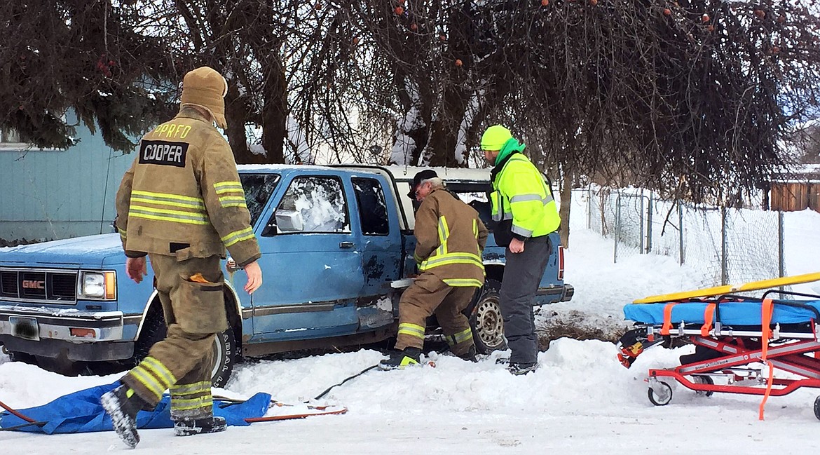 First responders work to extricate the driver of a pickup who was involved in a two-vehicle wreck Monday in Plains. (Erin Jusseaume/ Clark Fork Valley Press)