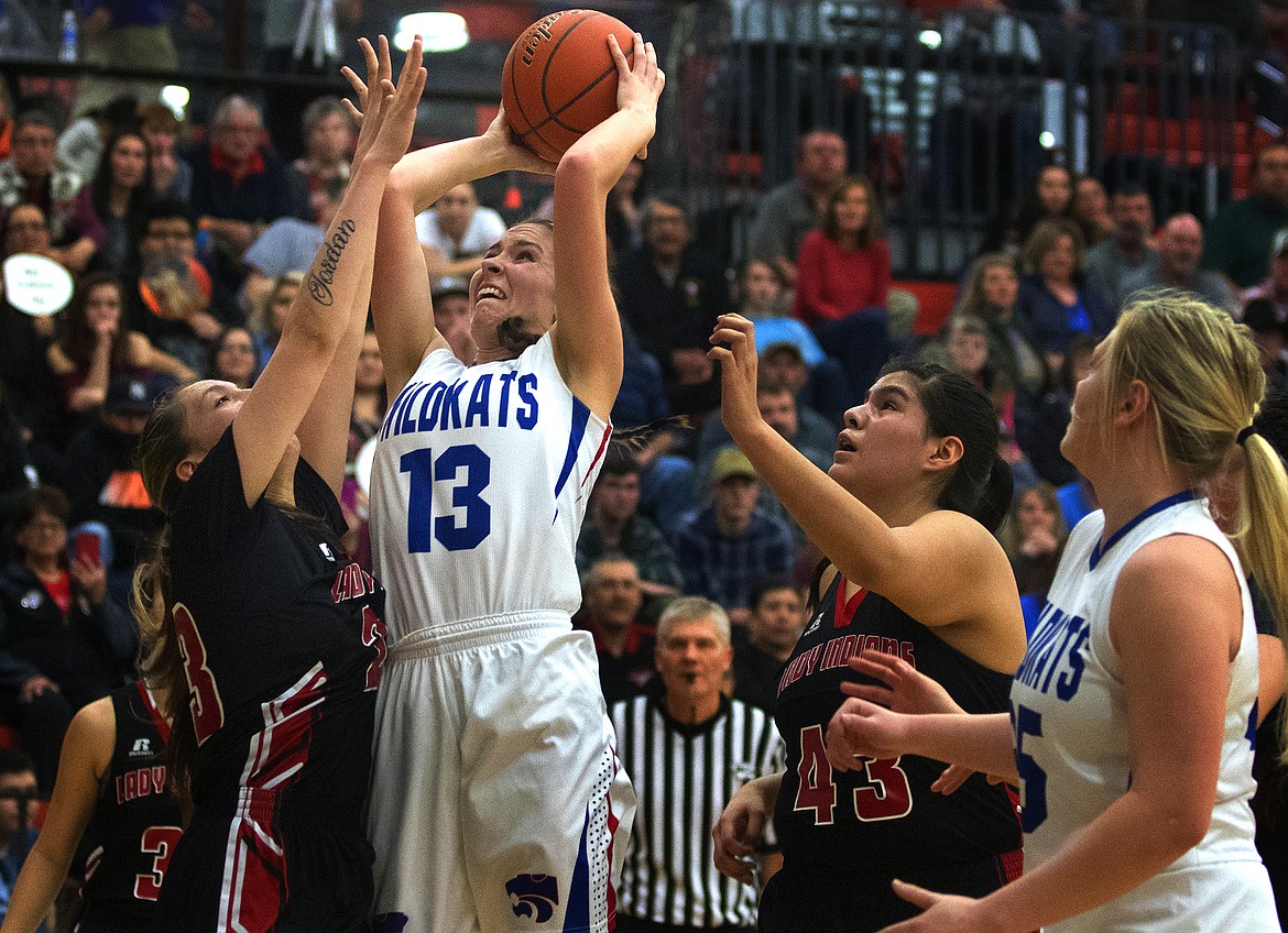 Hannah Gedlaman goes up for a shot in the paint against several Browning defenders in the district championship game in Ronan Saturday. (Jeremy Weber photo)