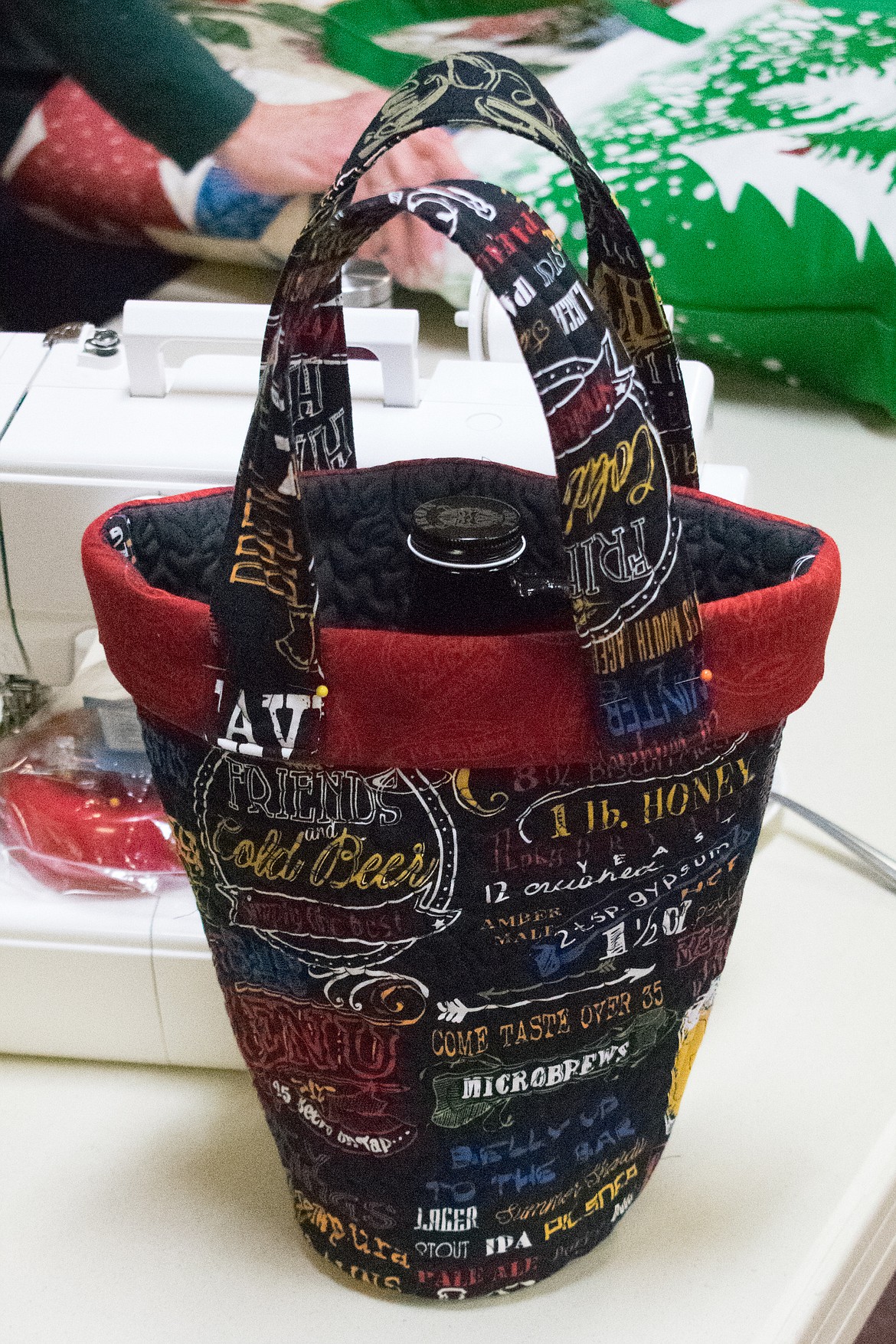 One of the quilted baskets for carrying a beer growler made by Sharon Gehrke. The foam batting helps to insulate. (Ben Kibbey/The Western News)