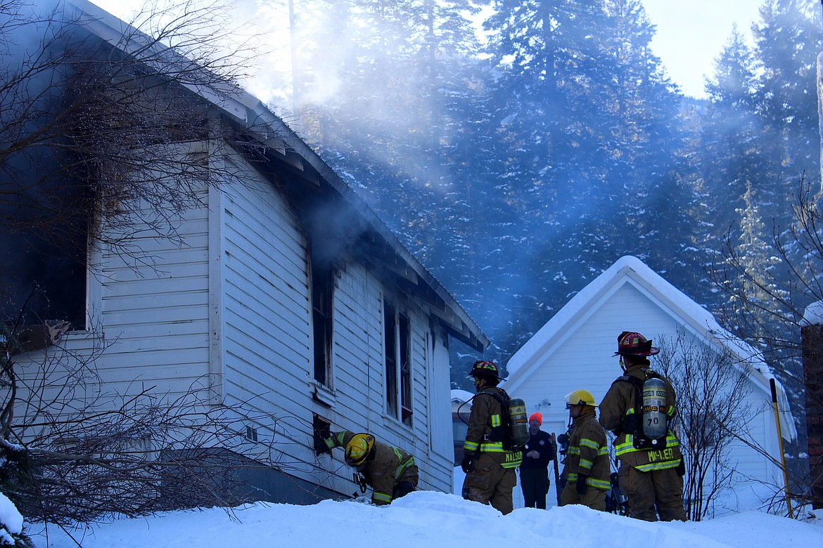 Photo by CHANSE WATSON
Firecrews continue to search the walls of the home for hidden hot spots after the main fire was extinguished.