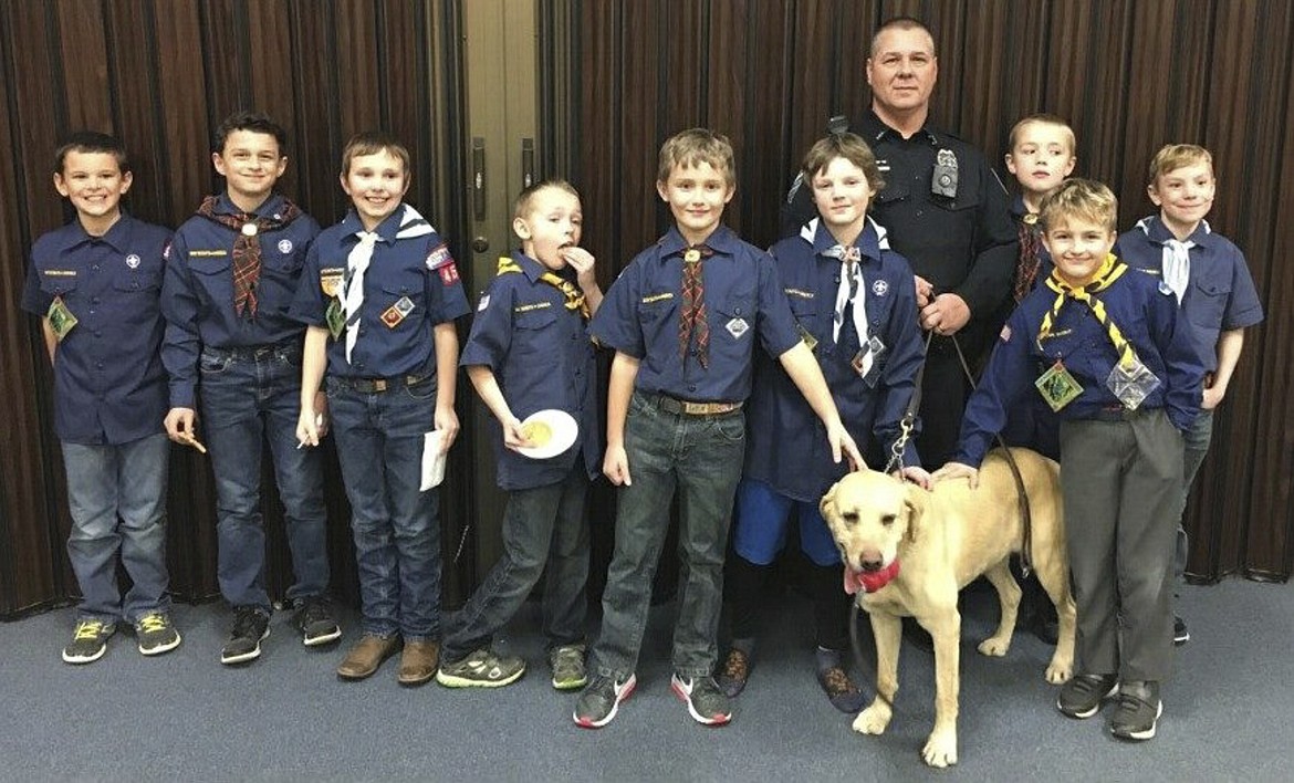 PACK 4947 of Polson visited Brody and his handler Captain Alan Booth at the Polson Police Department earlier this year. Brody works well with children, oftentimes putting them at ease during stressful calls, Booth explained. As he ages, Brody does more public relations for the department, visiting with local childrens&#146; groups. (Photo provided courtesy of Polson Police Department Facebook page)