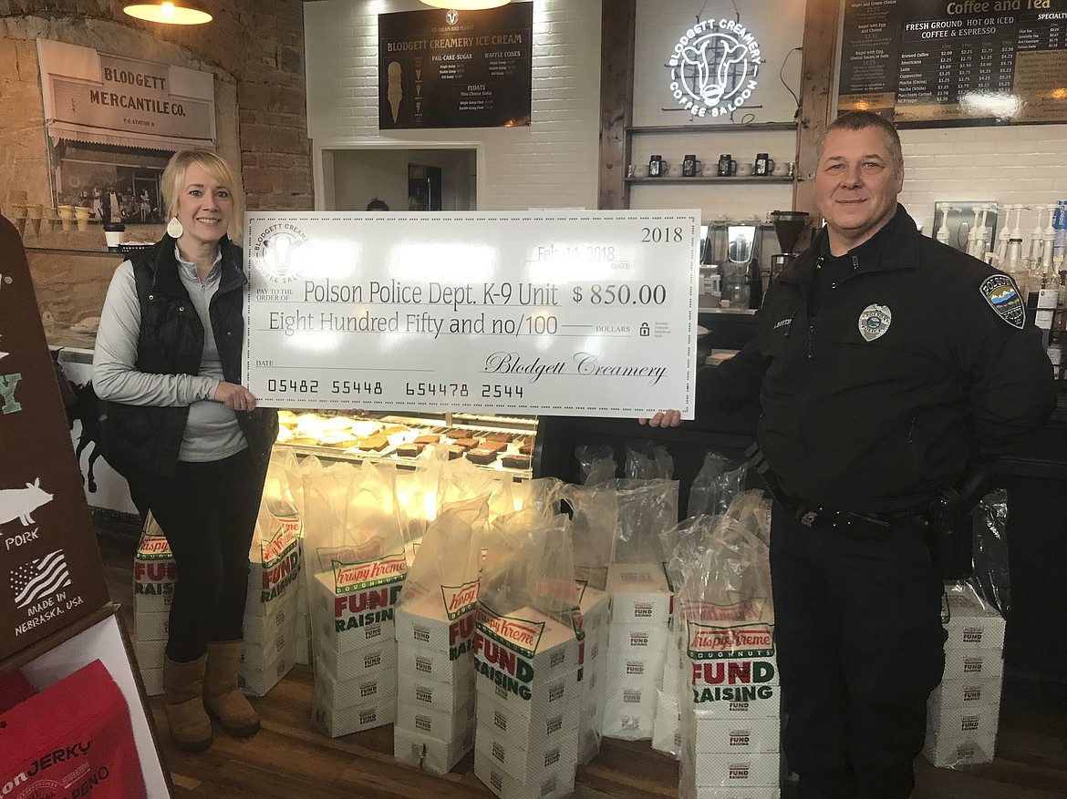 DEBRA BLODGETT, left, is pictured with Polson Police Department Captain Alan Booth on Valentine's Day. Blodgett, who owns Blodgett Creamery in Polson with husband, Jeff, held a donut fundraiser, donating $850 toward a new K-9 for the department. (Photo courtesy of Blodgett Creamery)