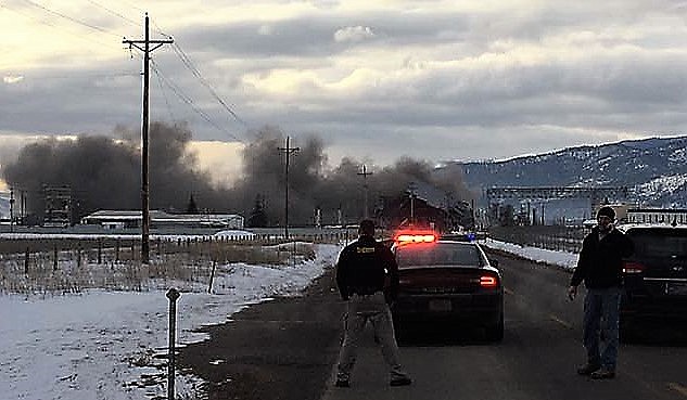 Missoula Sheriff and members of the Frenchtown Rural Volunteer Fire Department helped block Mullan Road on Feb. 1 as a building was exploded for deconstruction at the old Smurfit-Stone Mill site. (Photo courtesy of the Frenchtown Rural Volunteer Fire Department).