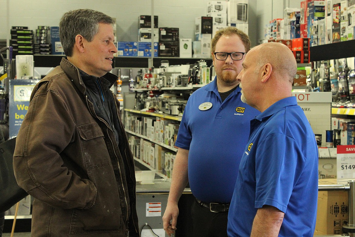 U.S. Senator Steve Daines, R-Mont., speaks with assistant store manager James Scott, center, and general manager Bob Bridges at Kalispell&#146;s Best Buy Tuesday (Patrick Reilly/Daily Inter Lake)