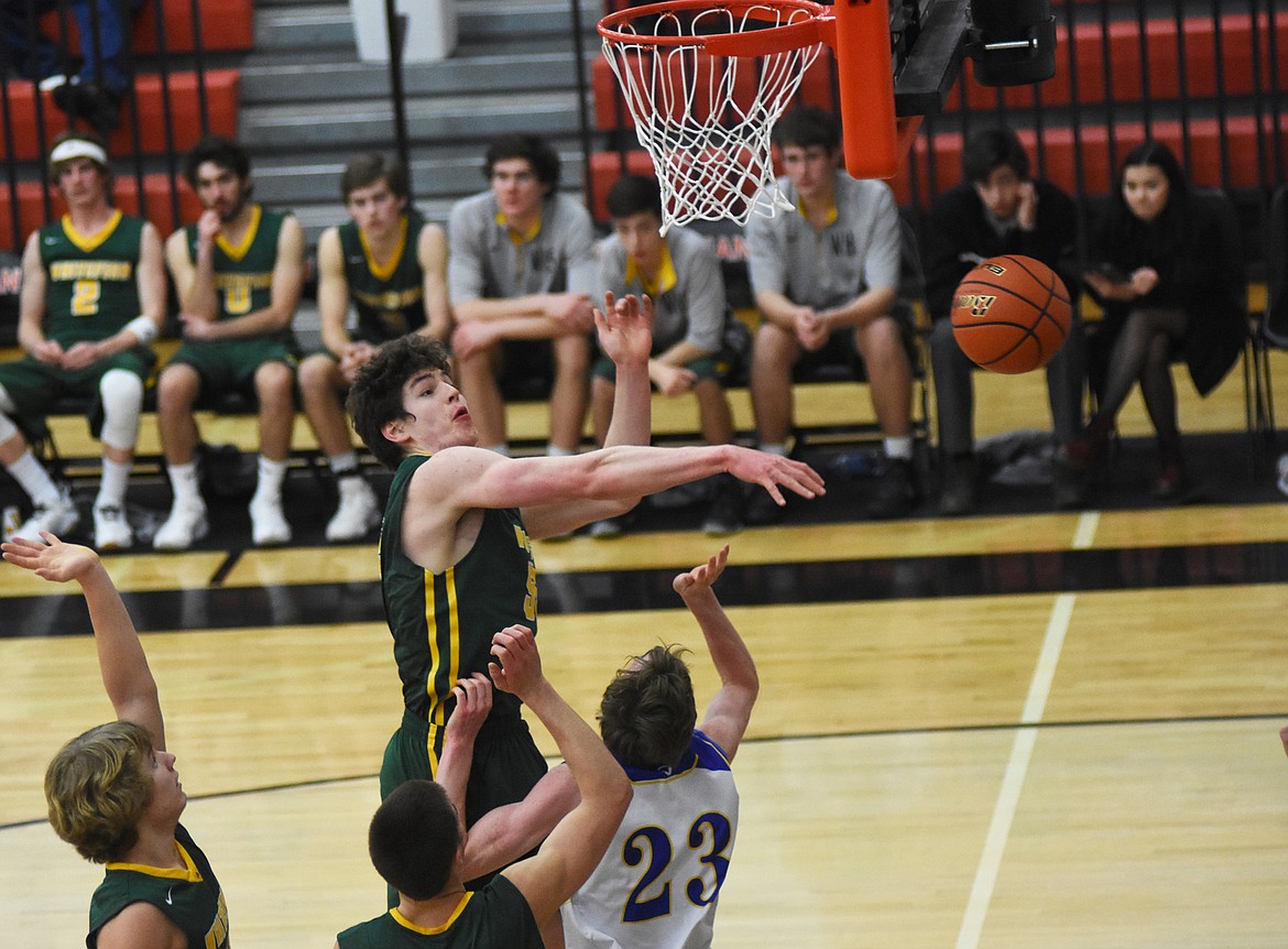 Dillon Botner swats away a Ryggs Johnston shot against Libby in the Northwest A District Tournament in Ronan Thursday. (Daniel McKay photos/Whitefish Pilot)