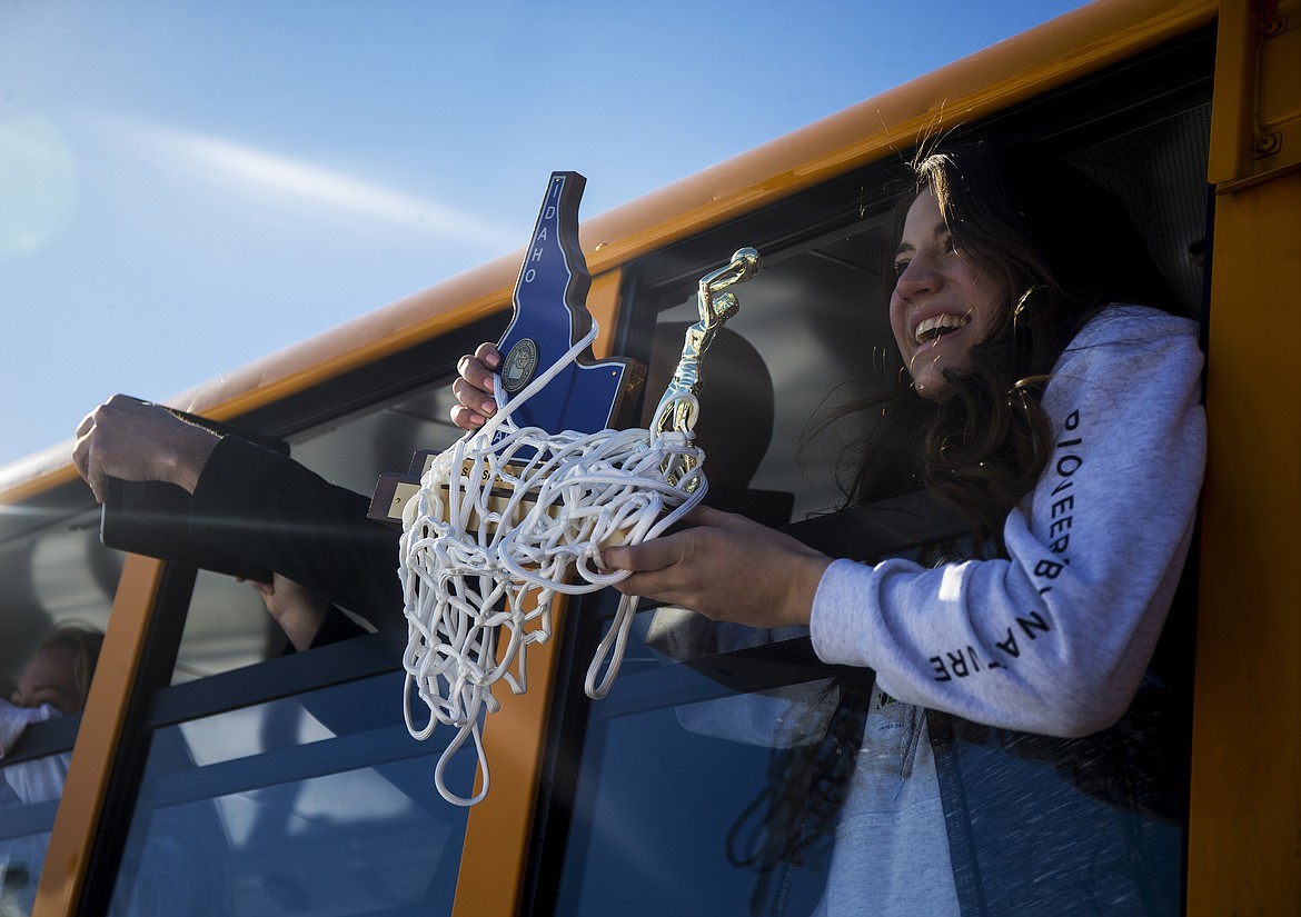 Post Falls High School senior Melody Kempton holds the 5A State Championship Trophy as the team arrives Monday afternoon at school. (LOREN BENOIT/Press)