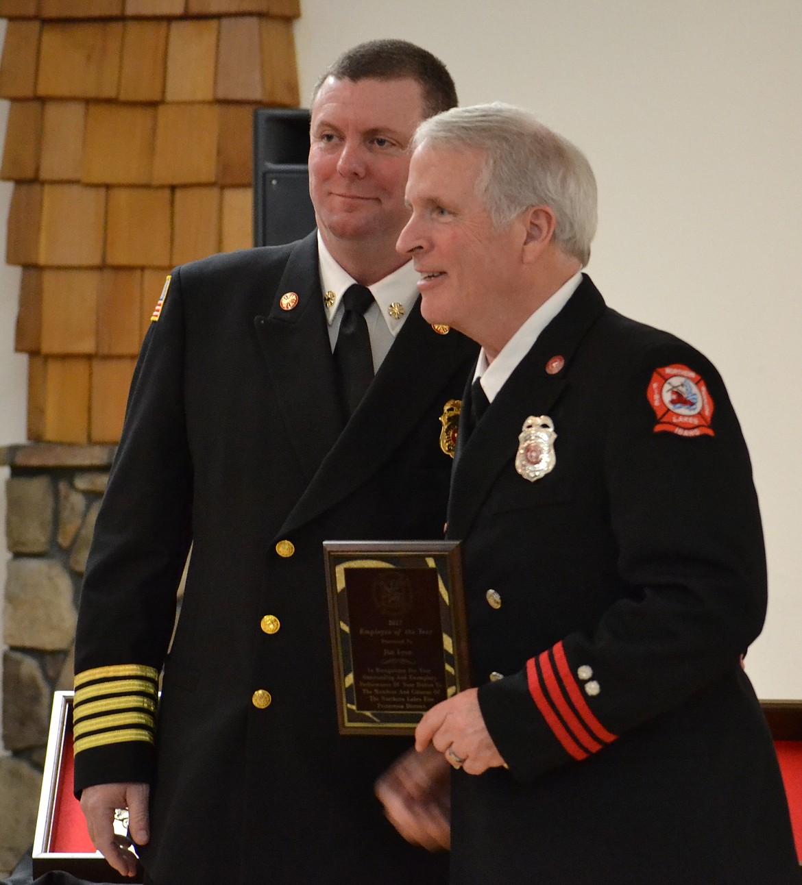 Deputy Fire Marshal Jim Lyon, right, receives Northern Lakes Fire District&#146;s Employee of the Year Award from Chief Pat Riley.