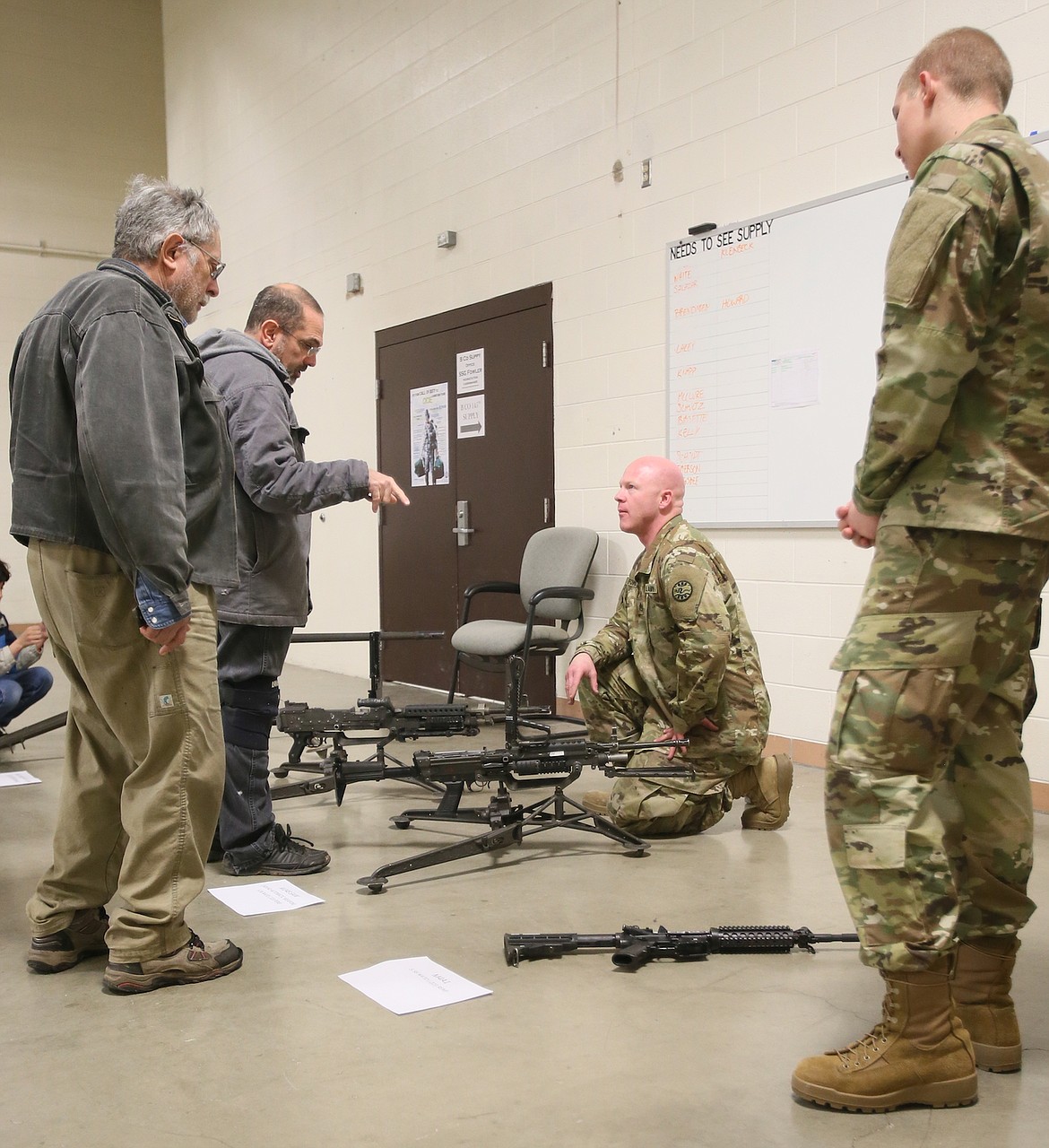 During an open house at the Idaho Army National Guard Armory in Post Falls Thursday, veterans Mark Glenn and Owen Mir discuss the Army&#146;s current weaponry with Staff Sgt. Nick Fowler of Coeur d&#146;Alene and Pvt. Ty Ward of Priest River. &#147;Everything&#146;s changed,&#148; said Mir. (Judd Wilson/PRESS)