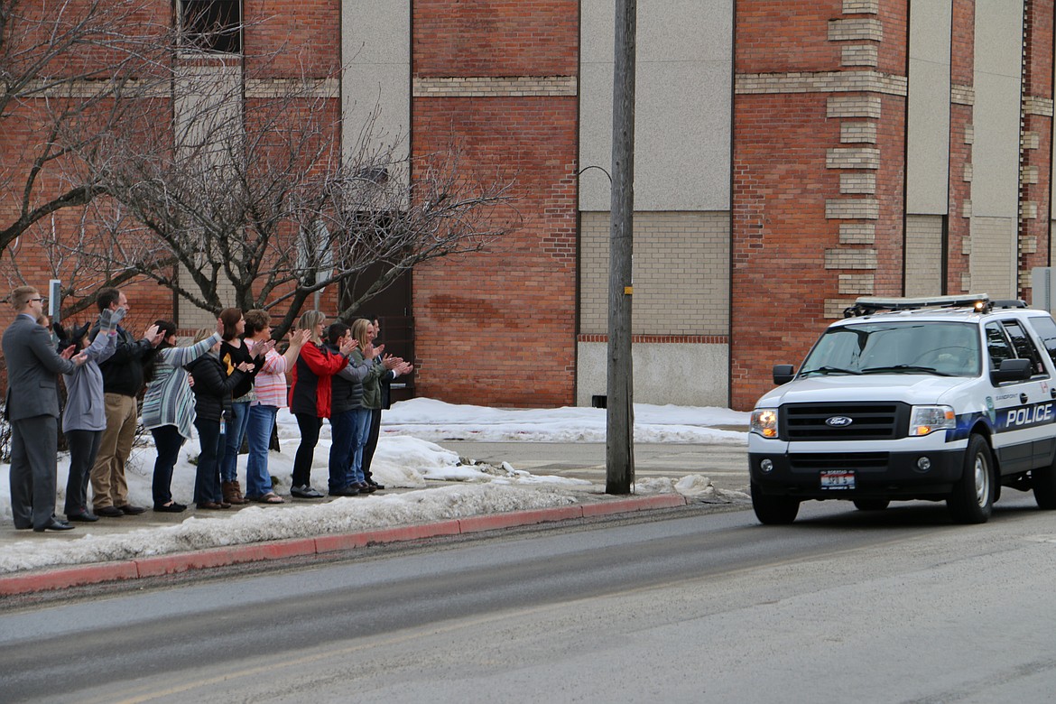 (Photo by MARY MALONE)
A crowd outside the Bonner County Prosecutor&#146;s Office cheered as a procession of law enforcement made their way into town, escorting Sandpoint Police Officer Eric Clark home after undergoing surgery at Kootenai Health in Coeur d&#146;Alene. Clark and fellow Officer Michael Hutter were injured during a shooting early Monday morning.