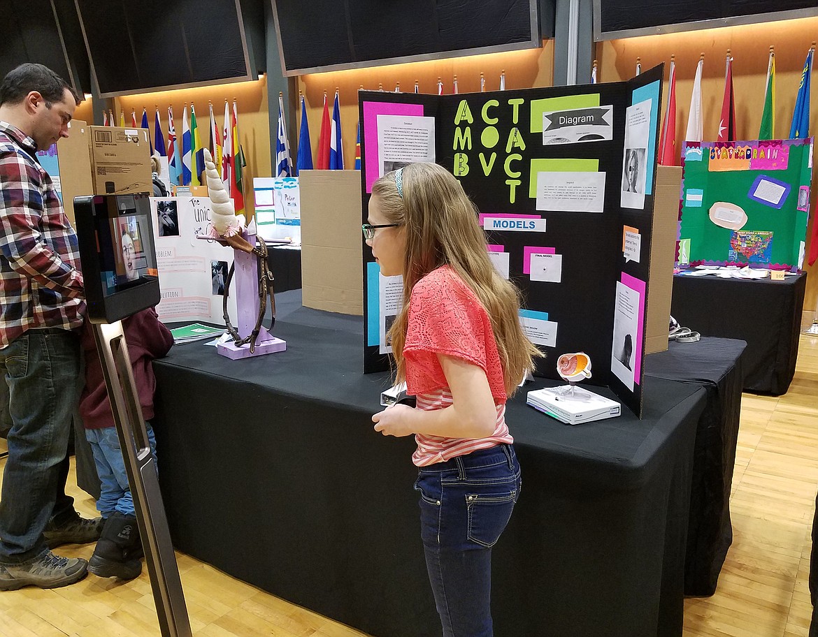 Courtesy photo
North Idaho STEM Charter Academy seventh-grader Alisha Davidson chats with &#147;Beam&#148; the telepresence robot during the Invent Idaho State Finals in Moscow last weekend. Alisha is one of 16 young inventors who will advance to the National Invention Convention at the Henry Ford Museum of American Innovation in Dearborn, Mich. May 31-June 3. Alisha invented the &#147;Amblyopia Cov-Tact,&#148; a dyed contact that discreetly corrects lazy eye so kids won&#146;t get picked on for wearing an eye patch.