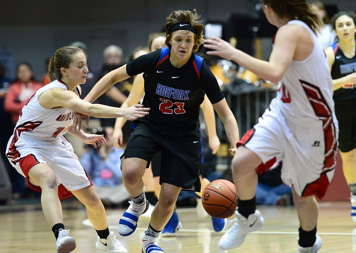 Bigfork's Rakiah Grende brings the ball upcourt under pressure from Three Forks defenders Shainy Mack, left, and Kyle Olson during the fourth quarter in the semifinals of the 2018 State Class B Girls' Basketball Tournament at the Adams Center in Missoula on Friday, March 9. (Casey Kreider/Daily Inter Lake)