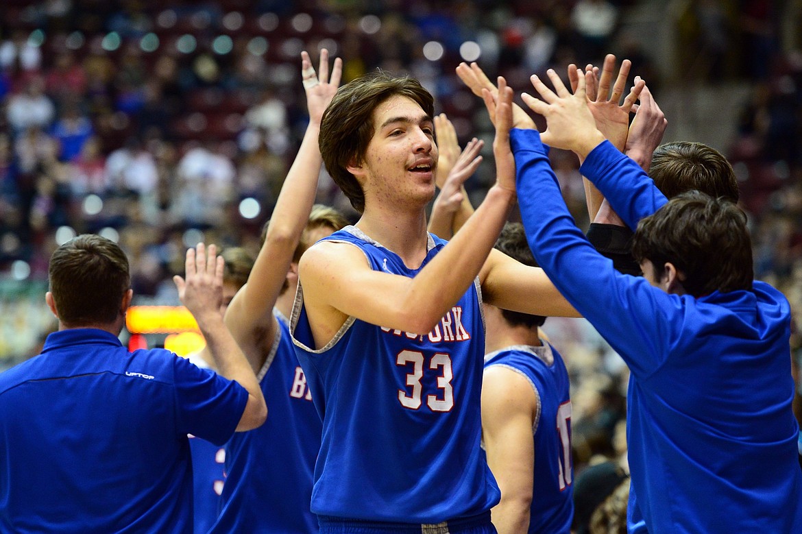 Bigfork's Beau Santistevan is congratulated by teammates after a 60-45 semifinal victory over Rocky Boy in the 2018 State Class B Boys' Basketball Tournament at the Adams Center in Missoula on Friday, March 9. (Casey Kreider/Daily Inter Lake)