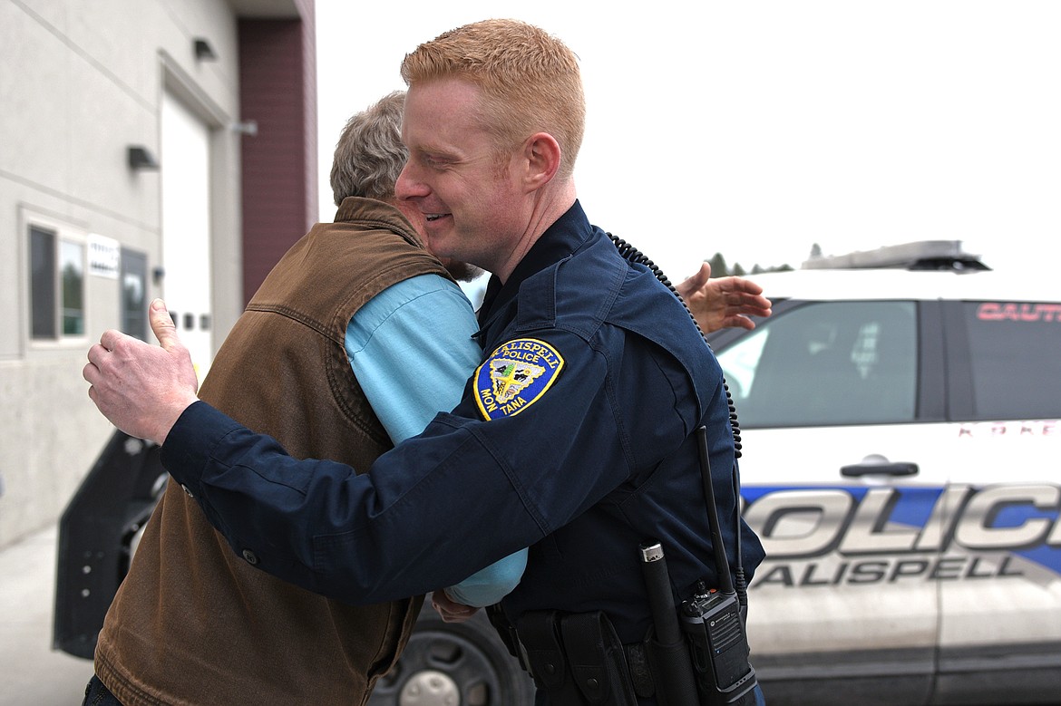 Kalispell Police Department officer Jason Parce hugs Eric Brown after meeting for the first time on Friday, March 2. Brown suffered a heart attack outside his job at Flathead Valley Community College last May and Parce responded to the scene to start resusication on Brown. (Casey Kreider/Daily Inter Lake)