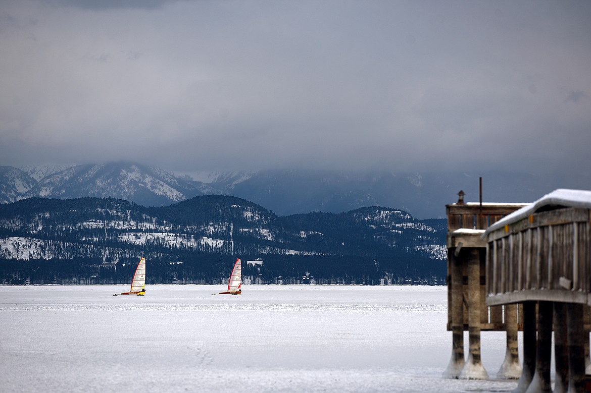 Dave Farmer, left, and John Eisenlohr sail across the frozen surface of Flathead Lake in Lakeside on Feb. 23. (Casey Kreider/Daily Inter Lake)